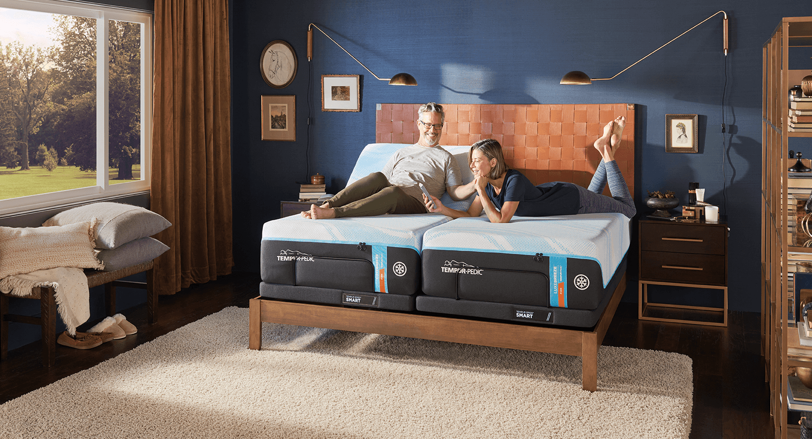 TEMPUR-Ergo® Smart Base — A couple laying on a split king mattress in a decorated room